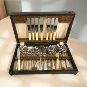 An oak canteen of Kendal stainless cutlery