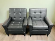 A pair of 20th century Scandinavian stitched and buttoned black vinyl armchairs,