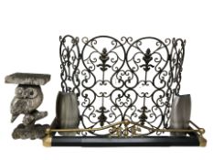 A wrought metal fire screen, wooden stand in the form of an owl,