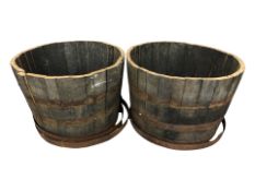 A pair of coopered oak barrel planters,
