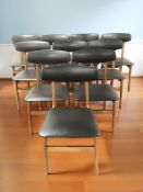 A set of ten teak and black vinyl dining chairs