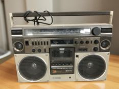 A Hitachi three-way portable stereo radio cassette recorder with lead