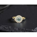 An 18ct yellow gold blue zircon and diamond ring, size N.