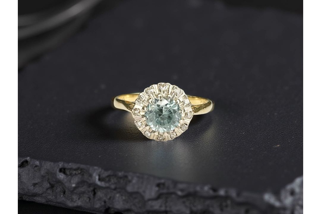 An 18ct yellow gold blue zircon and diamond ring, size N.