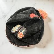 A cap with Newcastle and Garter coat of arms