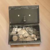 An enamel cash tin containing assorted British coins,