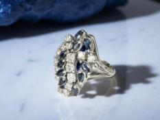 An 18ct gold sapphire and diamond ring, approximately 0.7ct, size L.