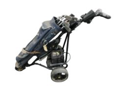 A Powakaddy Freeway II electric golf caddy and bag containing several clubs,