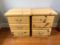 A pair of modern pine effect three drawer bedside chests,
