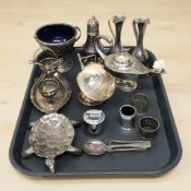 A group of silver plated wares including oil lamp, table lighter, egg cruet,