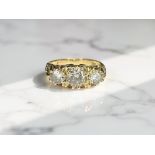 An 18ct gold diamond three stone ring, the central stone approximately 0.
