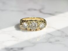 An 18ct gold diamond three stone ring, the central stone approximately 0.