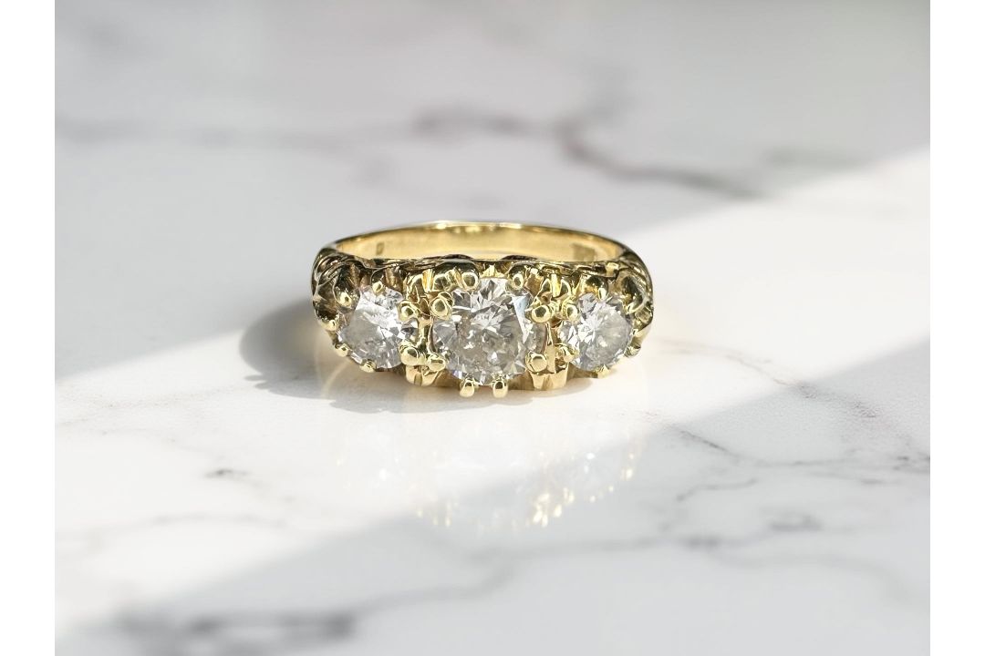 An 18ct gold diamond three stone ring, the central stone approximately 0.