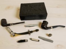 An embossed leather box containing a silver-mounted pipe, Falcon pipe, ARP whistle,