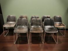 A set of eight mid 20th century black leather covered bucket chairs on metal legs