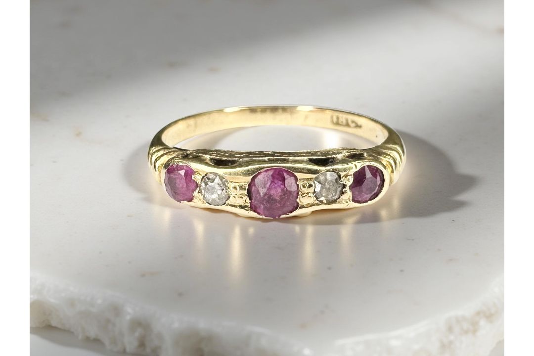An 18ct yellow gold ruby and diamond ring, size N. CONDITION REPORT: 2.