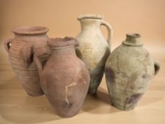 Four antique earthenware jugs,