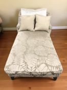 A modern chaise longue in floral fabric,