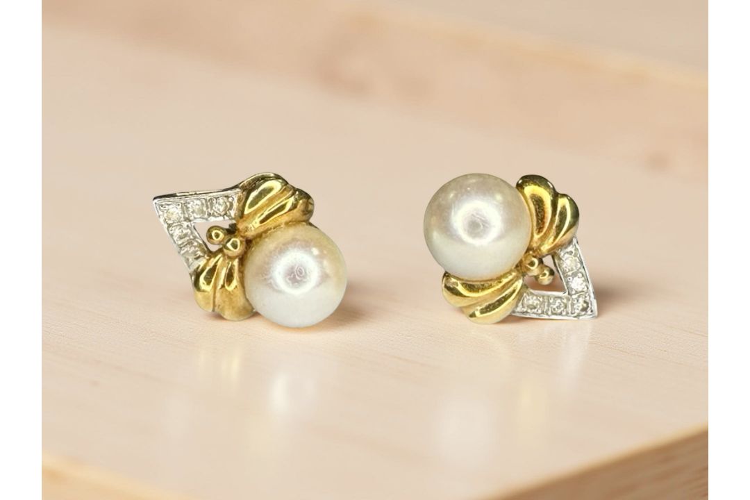 A pair of 18ct yellow gold pearl and diamond earrings