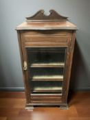 A Victorian walnut glazed single door music cabinet,
