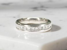 An 18ct white gold princess cut half eternity ring, approximately 0.