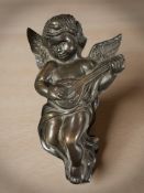 A bronze cherub wall plaque,
