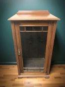 A glazed walnut single door cabinet,