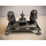 A novelty silver-plated desk stand surmounted by a pair of owls with glass-inset eyes,