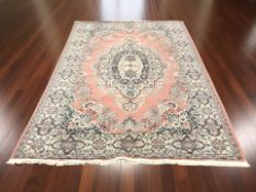 A 20th century woolen carpet of Iranian design on pink ground,