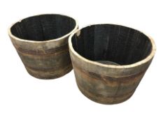 A pair of coopered oak barrel planters,