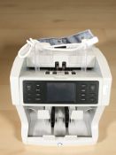 A Safescan digital money counting machine with lead