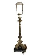 A continental gilt metal table lamp on triangular black marble plinth,