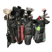 Four golf bags containing assorted irons and drivers including Wilson,