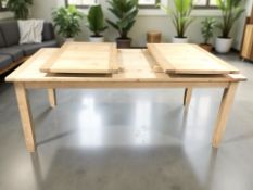 A pine rectangular pullout extending dining table with two leaves,