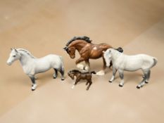 A group of four Beswick horses.