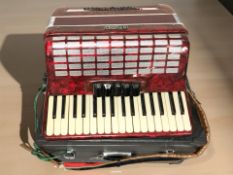 A Studio piano accordion, in box.