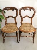A pair of Victorian mahogany and cane seated occasional chairs.