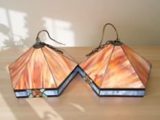 A large pair of Tiffany style hexagonal stained glass pendant light shades, diameter 50 cm.