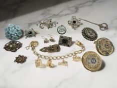 A gold-plated charm bracelet, several vintage paste-set brooches, silver brooch,
