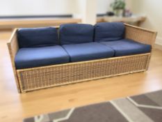 A Scandinavian wicker three seater day bed, 205 cm x 83 cm x 67 cm.