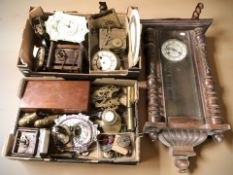 A group of various wall clocks, movements and parts.