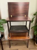 A reproduction mahogany curved rectangular coffee table and a further trolley.