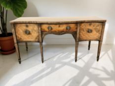 A George III mahogany serpentine front three drawer sideboard,