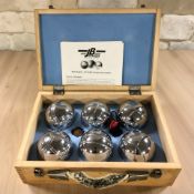 A set of lawn boules in box.