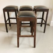 A set of four bar chairs with black vinyl seats, height 78 cm.