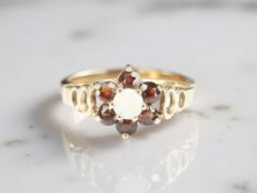 A 9ct gold opal and garnet cluster ring, size L½ CONDITION REPORT: 1.