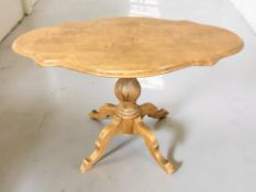 A reproduction stained pine shaped topped pedestal occasional table,