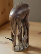 An African carved hardwood figure group of an antelope and foals, height 64 cm.