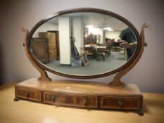 A large late Victorian mahogany and satin wood banded bow-front dressing table mirror fitted with