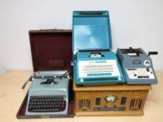 A vintage style music player and three various typewriters.